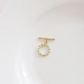 Close-up of golden toggle clasp with hammered texture for jewelry making and DIY crafts - Vine Weave Style / 14k