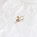 Minimalist golden spiral ear clip with gold bead on a white textured background - 18k With Bead And Rubber Stopper