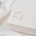 Minimalist 14K gold plated heart shaped hoop earring displayed on a white geometric block - Heart Shape (18K)