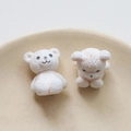 Detailed close-up of white flocked teddy bear charms for DIY jewelry and crafts - White