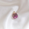 Detailed macro view of a glass sphere pendant with pink dried flowers and a gold metal cap - 6# Rose Red