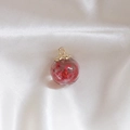 Transparent glass orb pendant with red dried flowers and golden metal floral cap - Red