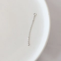 Macro shot of silver metal jewelry extension chain with fine link structure on white tray - 14# Single Hanging Long Fine Chain