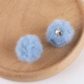 Detail of light blue fluffy pompoms with metal loops for DIY jewelry making - 10# Haze Blue