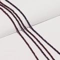 Macro shot of faceted crystal rondelle beads with purple and bronze iridescent finish - Phantom Purple