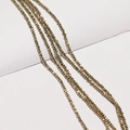 Detailed macro view of faceted gold metallic beads for DIY jewelry making and craft projects - Gold Champagne