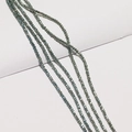 Macro view of iridescent grey-green faceted glass wheel beads for DIY jewelry making - Fantasy Blue