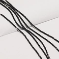 Close-up of 2mm black faceted glass crystal beads for DIY jewelry and necklace making - Black
