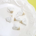 Close-up of elegant white bead fan tassels with golden floral caps for DIY jewelry - White Crystal