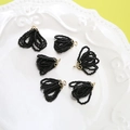 Macro detail of six black beaded fringe pendants with embossed gold metal flower caps - Black Crystal