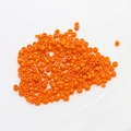 Macro shot of 2mm orange ceramic seed beads for DIY jewelry and necklace crafting - 10 g / Orange