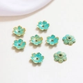 Detailed view of eight blue enamel and gold flower beads for DIY jewelry making - Style 4 (D1284)