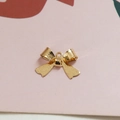 Golden alloy bow pendant charm for DIY jewelry making featuring a textured metal finish - Bow