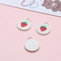 Macro shot of three strawberry charms with red enamel and white base for DIY jewelry - Strawberry Round Tag