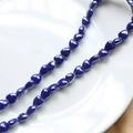 Macro detail of glossy dark blue heart ceramic beads for DIY jewelry making and crafts - Royal Blue