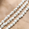 Close-up of polished white heart-shaped ceramic beads for DIY jewelry making accessories - White