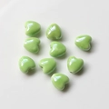 Macro shot of light green heart-shaped ceramic beads with smooth glaze and center holes - 15#Light Green