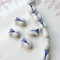 Macro detail of tulip-shaped blue and white porcelain beads for DIY jewelry making - Tulip Bud Shaped Bead (7#)