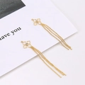 Detailed view of gold plated star flower earrings with clear zircon and triple bead tassels - Geometric Square Style / Gold
