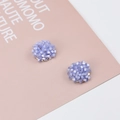Close-up of handmade lavender beaded flower stud earrings with gold-tone base - Lavender