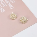 Macro shot of ivory floral bead cluster earrings with gold metal base studs - Milky White