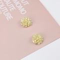 Macro detail of handmade cream yellow seed bead flower earrings on a pink artistic card - Light Yellow