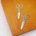 Detailed view of antique silver scissor charms with vintage engraved patterns on wood - Scissors (3#)