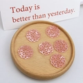 Detail of pink resin floral hollow pendants on a wooden tray for DIY jewelry - Large Pink Chinese Knot Style
