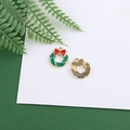 Detailed view of Christmas wreath charms with green enamel and red bows on golden metal - Christmas Wreath (Round 2)