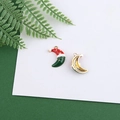 Detailed macro view of a Christmas moon alloy charm with red hat and gold stars - Christmas Moon