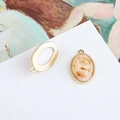 Close-up of vintage oval shell pendant with gold beaded frame for DIY jewelry making - Off White