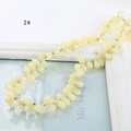 Detailed view of light yellow teardrop glass beads with silver spacers for DIY jewelry making - Milk Yellow