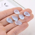 Detail of light blue crystal teardrop charms held in hand for DIY jewelry making - Light Blue