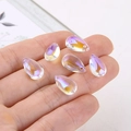 Detailed close-up of iridescent crystal teardrop pendants with top holes for DIY jewelry - Iridescent White