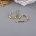 Close-up of golden curved U-shaped earring hooks for DIY jewelry making accessories - Geometric Pendant Style (2#)