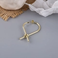 Close-up of golden metal knot stud earrings with a high-polished finish and minimalist design - Knot Geometric Style (1#)