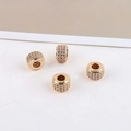 Macro detail of 14K gold plated bead charms with micro-pave cubic zirconia for jewelry DIY - 3D Cylinder