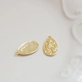Macro detail of 18k gold-plated coin pendants with embossed vintage figures and matte texture - Oval Figure (2#)