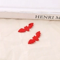 Close-up of red matte bat charms with threading holes for Halloween DIY jewelry making - Red Bat
