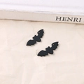 Detailed view of matte black bat pendants for DIY jewelry making on textured background - Black Bat