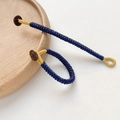 Macro shot of handmade dark blue and gold woven rope with a natural wooden bead fastener - Dark Blue Style (8# Price per Piece)