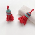 Detail of red handmade woven tassels with decorative silk thread knots and hanging loops - Style 15