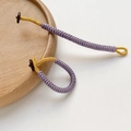 Detailed close-up of handmade purple woven cord keychain with gold thread and button - Purple Style (#7, 1 Piece)