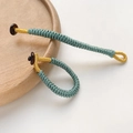 Macro detail of hand-woven solid color knots with golden thread and dark wood button closure - Cyan-Blue Style (No. 2 - Price per Piece)