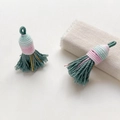 Macro view of dark green woven tassels with colorful thread detailing for DIY crafts - Style 9#