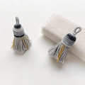 Close-up of grey woven tassels with metallic gold thread for DIY jewelry accessories - Style 6
