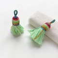 Close-up of handmade ethnic braided tassels with colorful silk threads for DIY crafts - Style 1