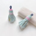 Detail of woven mint green tassel with gold silk threads and a blue hanging loop - Style 5