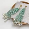 Detail of handmade beaded tassel earrings with green beads and white pearls on a tray - Single Piece / 1# Green