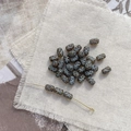 Macro shot of Czech glass beads with white cross pattern and vintage amber finish - 10# Clear Brown with Blue Line Cross Bead